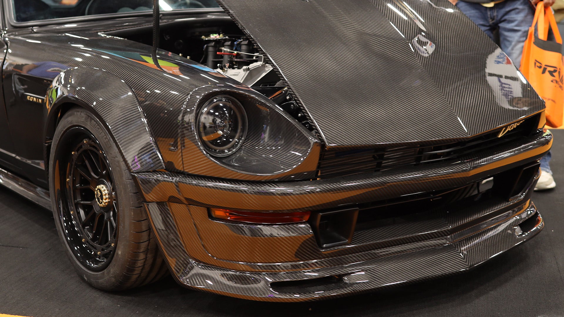 Carbon fiber car body on a vehicle with visible branding