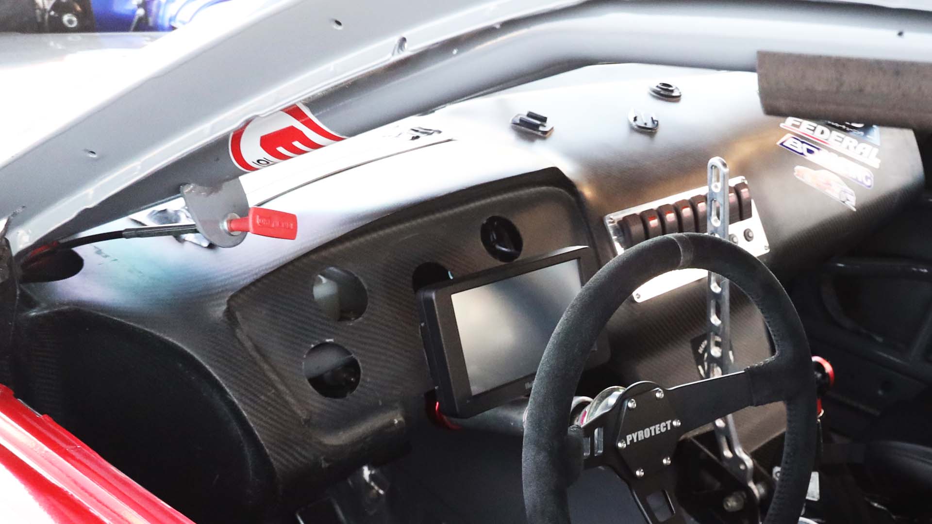 Close-up of a car's interior with steering wheel and dashboard