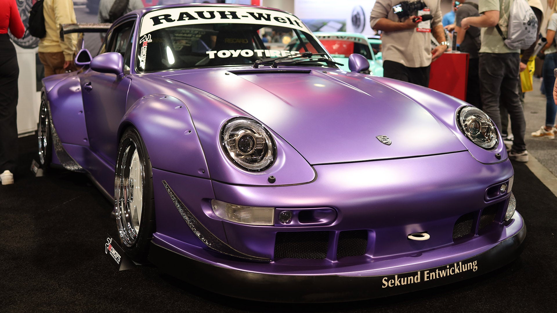 Purple sports car with visible branding at a car show