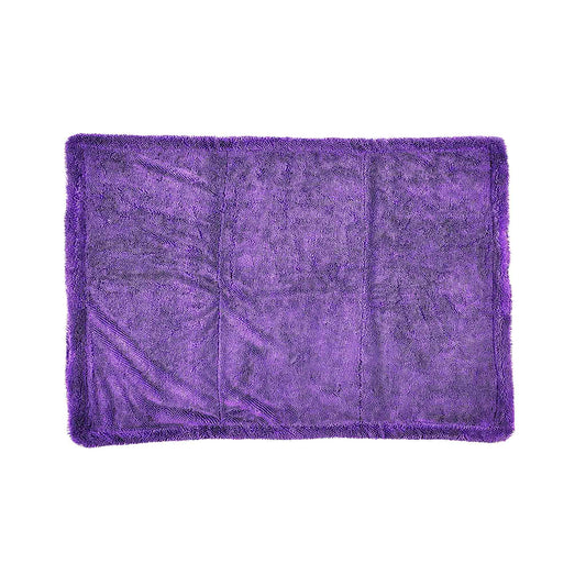 A rectangular purple plush microfiber towel with a shaggy texture and fringed edges, laid flat against a solid white background.