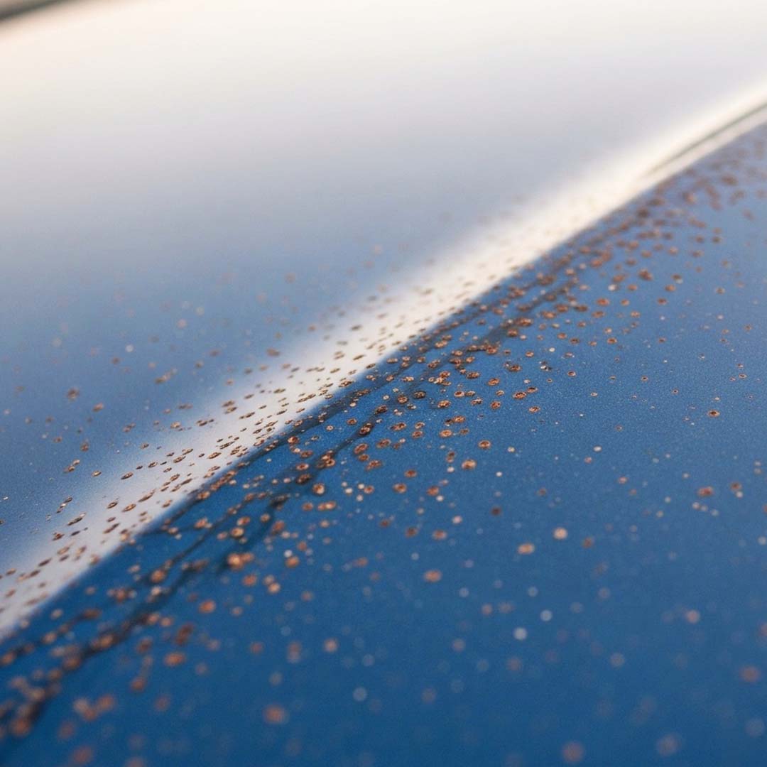 Close-up of a car's surface with dirt and grime